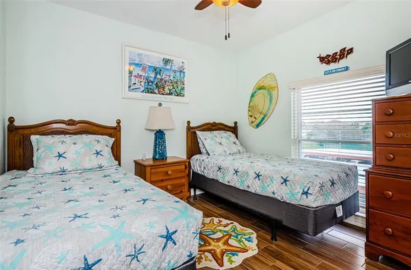 a bedroom with 2 bed and a window