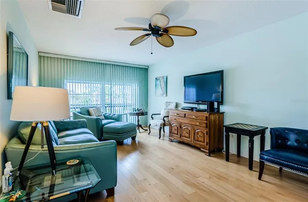 a living room with furniture and a wooden floor
