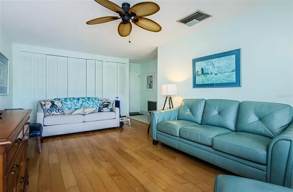 a living room with furniture and a wooden floor