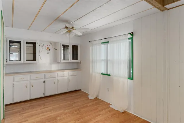 a spacious bathroom with a granite countertop sink and a mirror