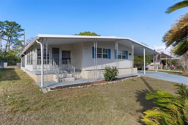 a view of a house with backyard and porch