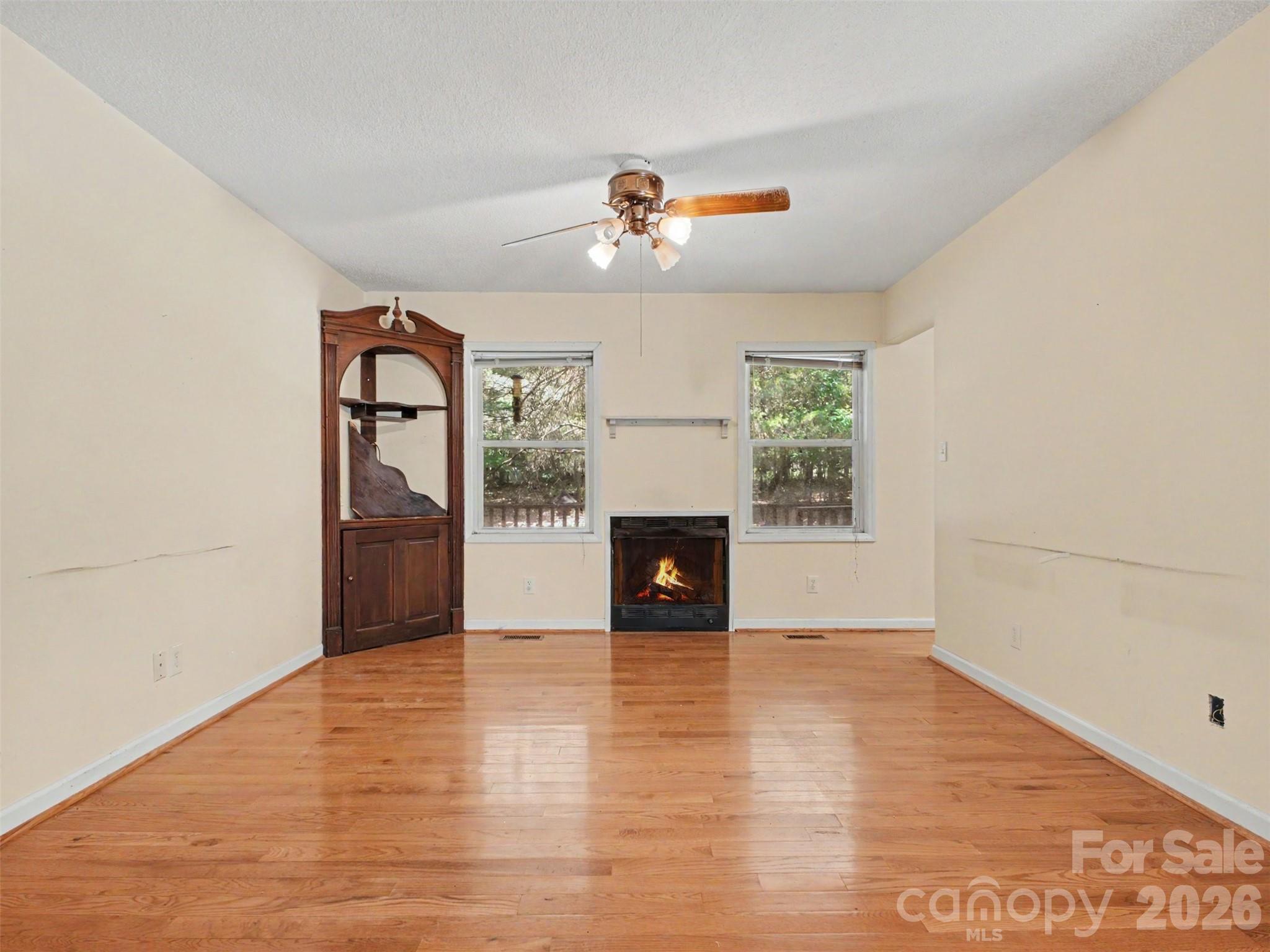 11109 Asbury Chapel Road Huntersville, NC 28078 - Photo 7 of 33 an empty room with windows and fireplace