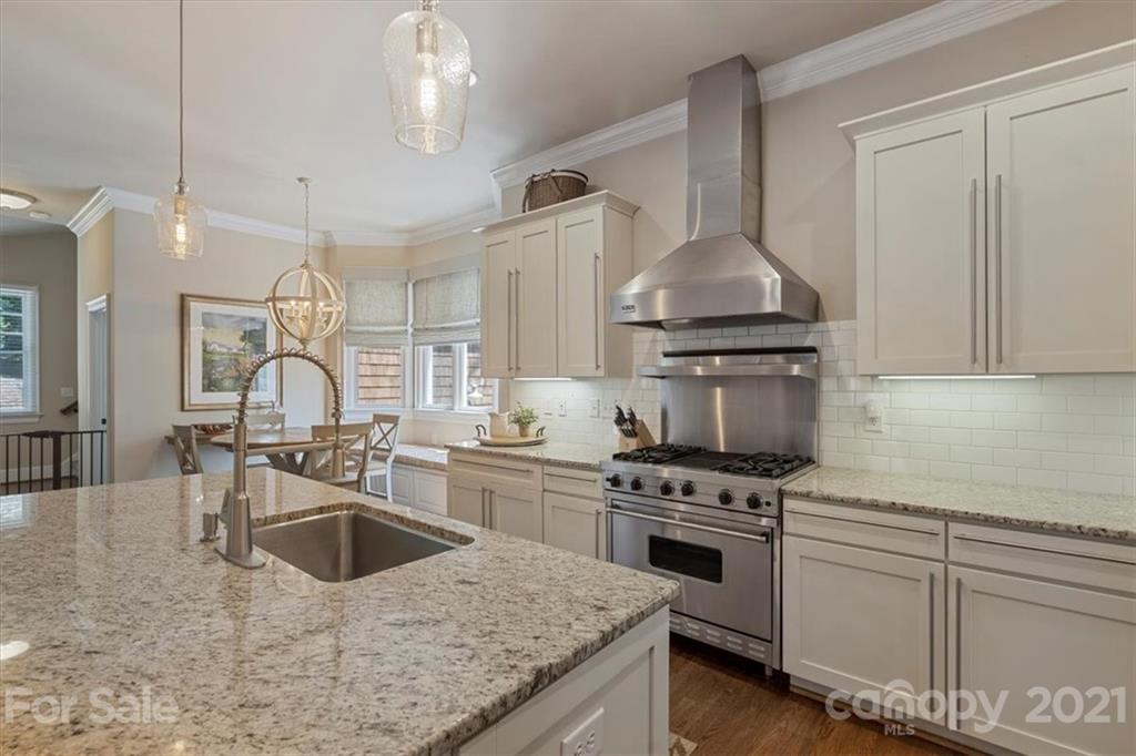 851 Stratford Run Drive Fort Mill, SC 29708 - Photo 12 of 48 a kitchen with granite countertop a sink stainless steel appliances and cabinets