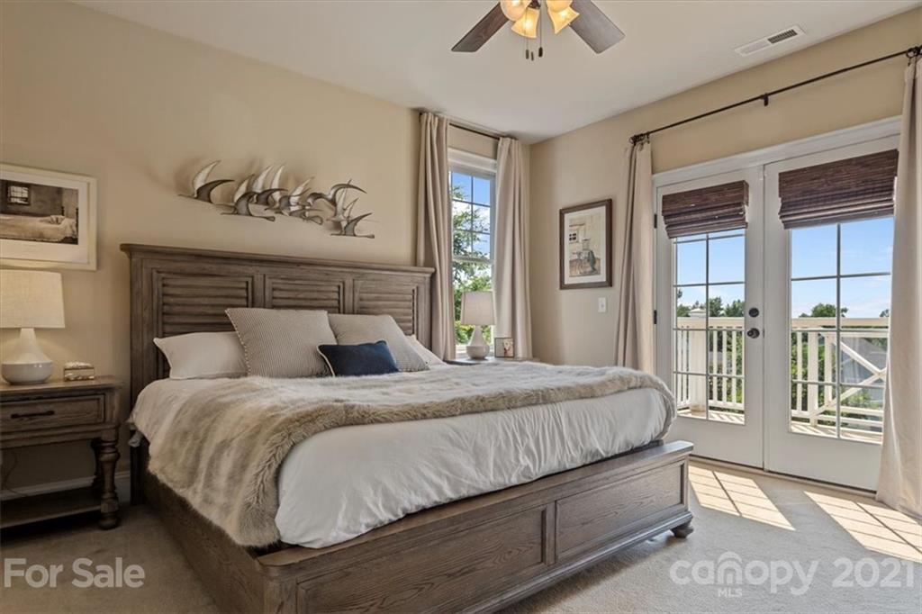 851 Stratford Run Drive Fort Mill, SC 29708 - Photo 23 of 48 a bedroom with a large bed and a chandelier