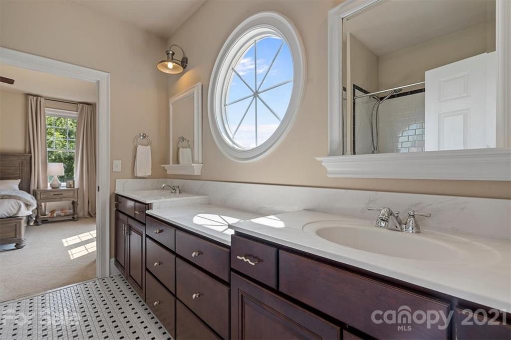 851 Stratford Run Drive Fort Mill, SC 29708 - Photo 27 of 48 a bathroom with a granite countertop double vanity sink a two mirror and a window