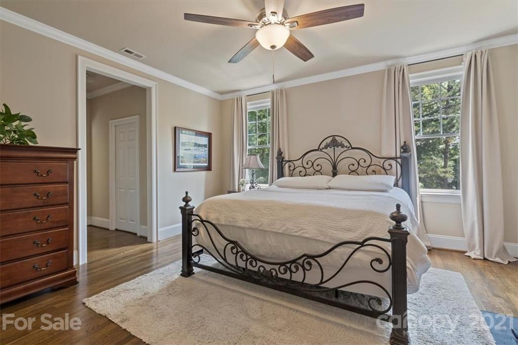 851 Stratford Run Drive Fort Mill, SC 29708 - Photo 29 of 48 a bedroom with a bed and a chandelier