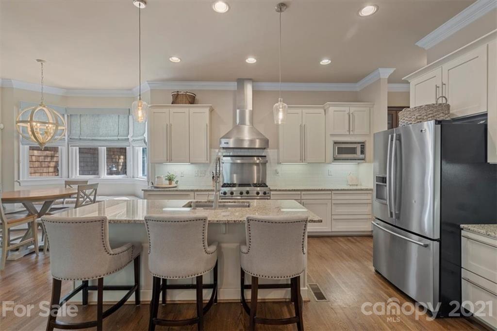 851 Stratford Run Drive Fort Mill, SC 29708 - Photo 10 of 48 a kitchen with stainless steel appliances granite countertop a dining table and chairs