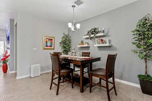 a view of a dining room with furniture and chandelier