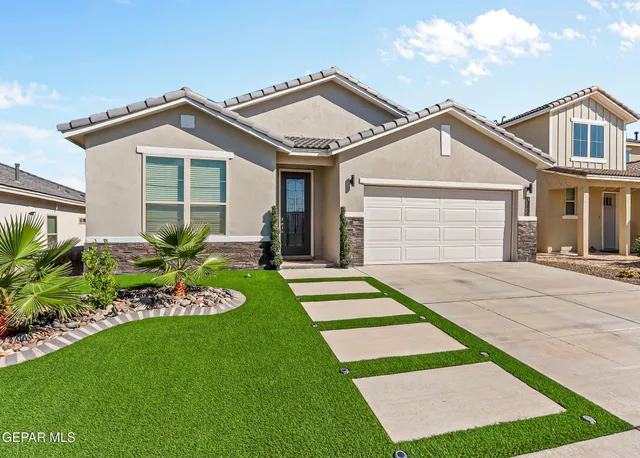 a front view of a house with a yard and porch
