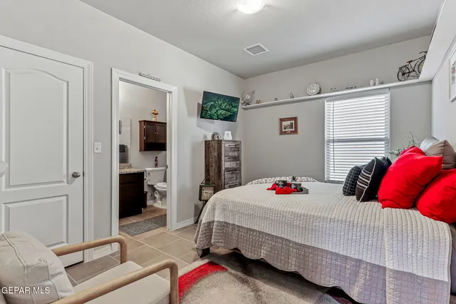 a bedroom with a bed and a couch