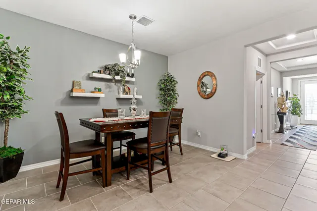 a dining room with a table and chairs
