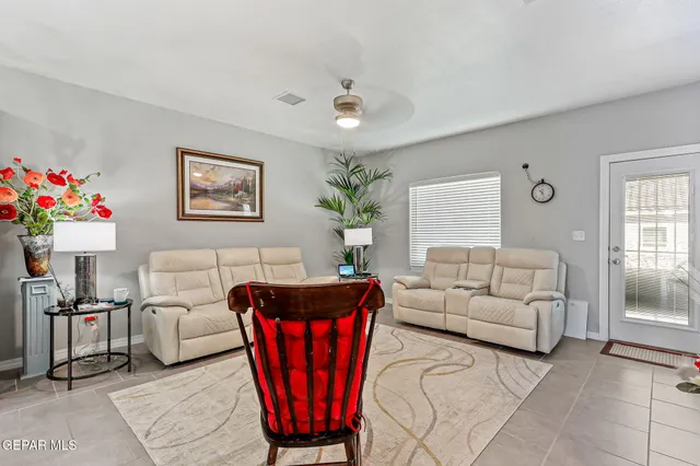a living room with furniture a chandelier and a window