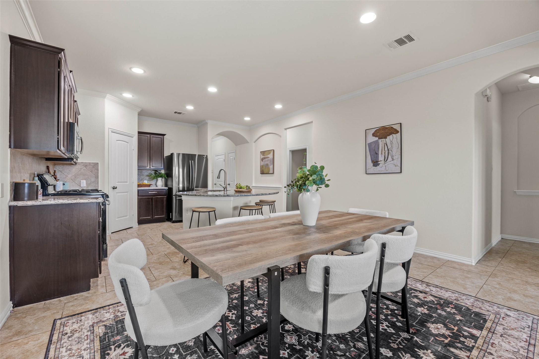 536 Rancho Verde Drive Leander, TX 78641 - Photo 6 of 37 a view of kitchen with refrigerator dining table and chairs