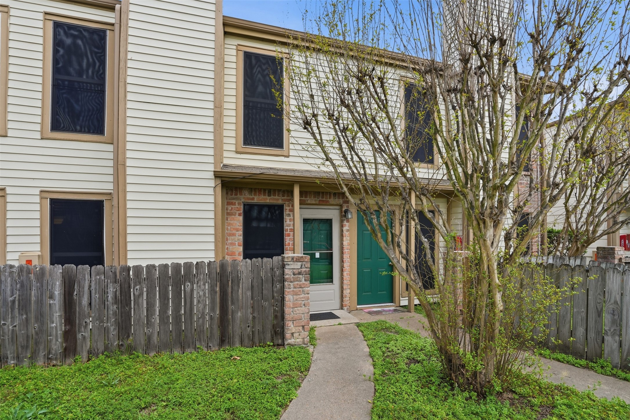 2200 Cypress Landing Road, Unit A3 Houston, TX 77090 - Photo 1 of 17 Follow the path to your future home. Charming exterior with a storm door to protect that gorgeous green front door.