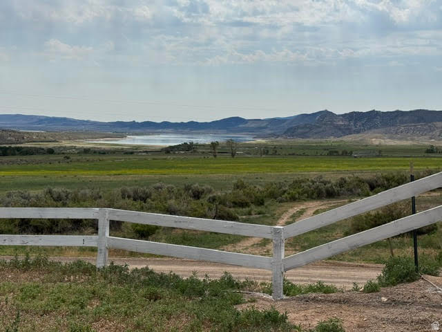1124 Washam Road Green River, WY 82938 - Photo 2 of 35 Expansive natural landscape featuring a wooden fence, dirt road access, and distant mountain ranges