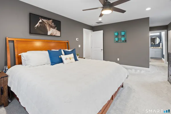 a bedroom with a bed and a painting on the wall