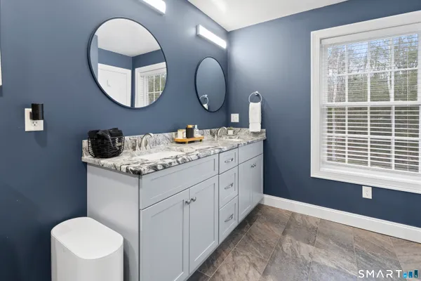 a bathroom with a toilet a sink and a mirror