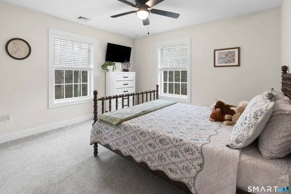 a bedroom with furniture and a window