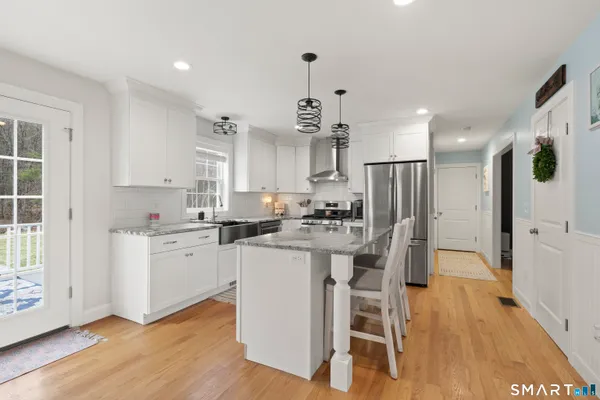 a kitchen with white cabinets and stainless steel appliances