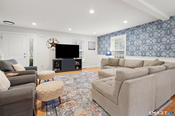 a living room with furniture and a flat screen tv
