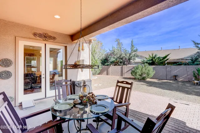 a view of a patio with table and chairs and potted plants