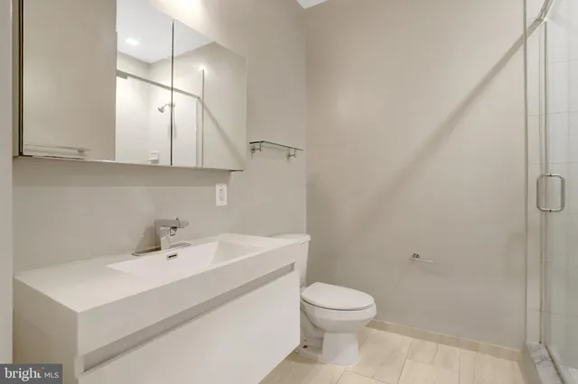 a bathroom with a sink a toilet and vanity