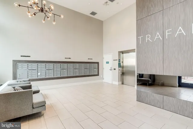 a living room with furniture and a chandelier