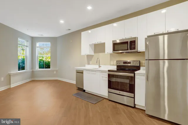 a kitchen with a refrigerator stove and microwave