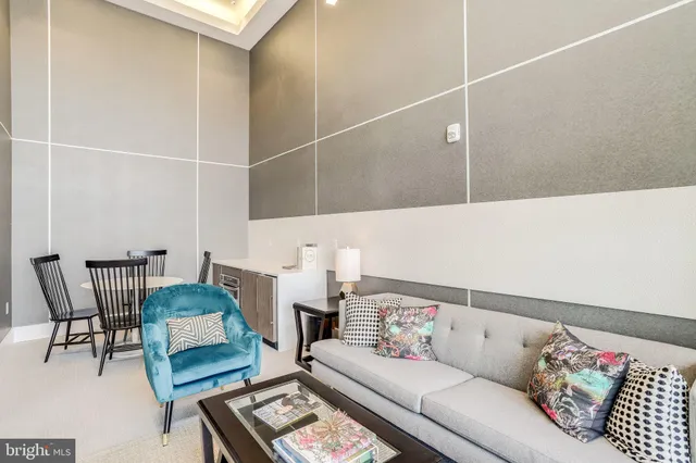 a living room with furniture and a rug