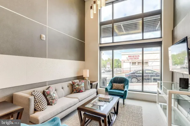 a living room with furniture and a large window
