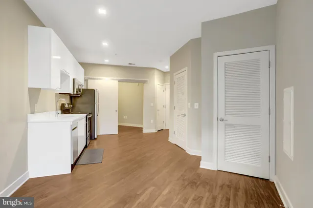 a view of a kitchen cabinets and wooden floor