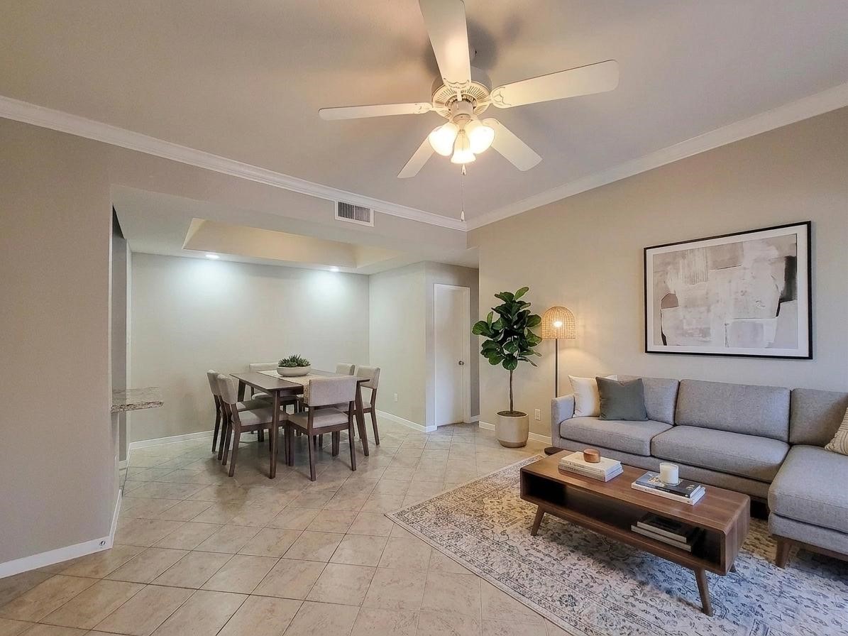 4041 Drake Street, Unit 116 Houston, TX 77005 - Photo 2 of 27 a living room with furniture a dining table and a potted plant