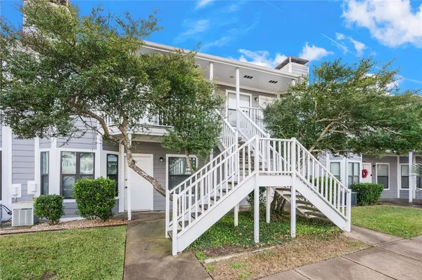 a view of a house with a yard and a deck