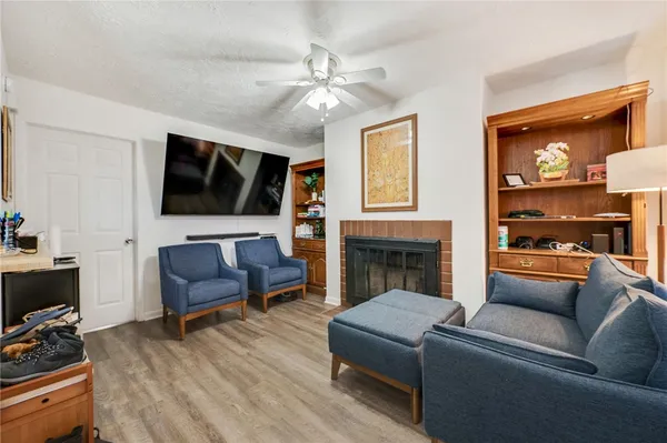 a living room with furniture fireplace and flat screen tv