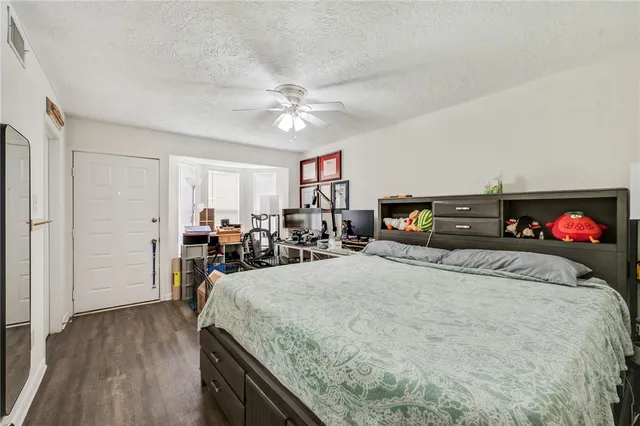 a bed room with a bed mirror and a lamp