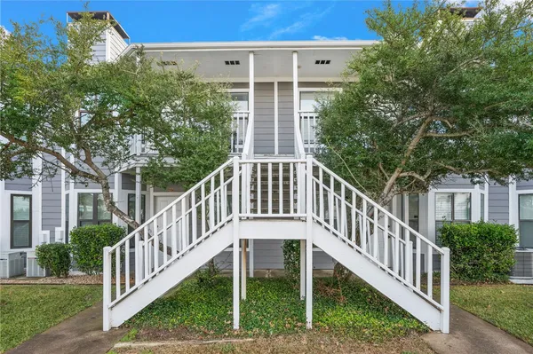 a view of a house with backyard and porch