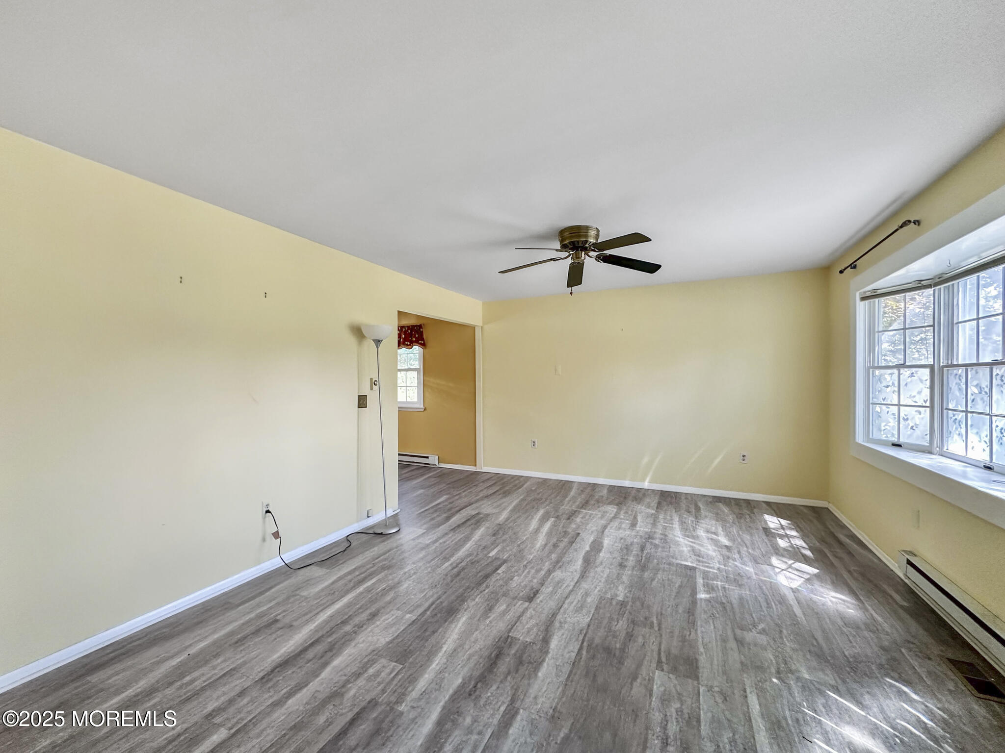 192 Dolphin Road Manahawkin, NJ 08050 - Photo 12 of 25 wooden floor in an empty room with a window