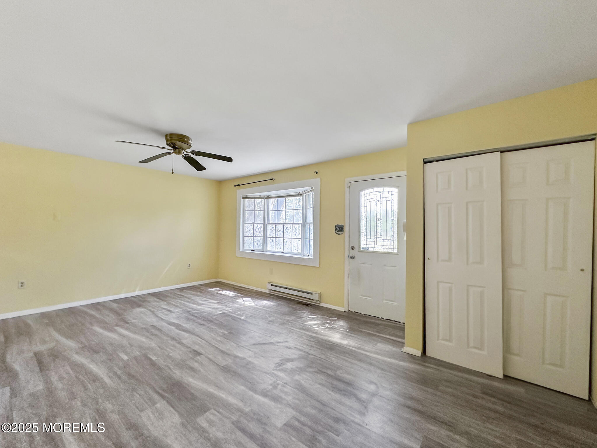 192 Dolphin Road Manahawkin, NJ 08050 - Photo 13 of 25 an empty room with wooden floor closet and windows
