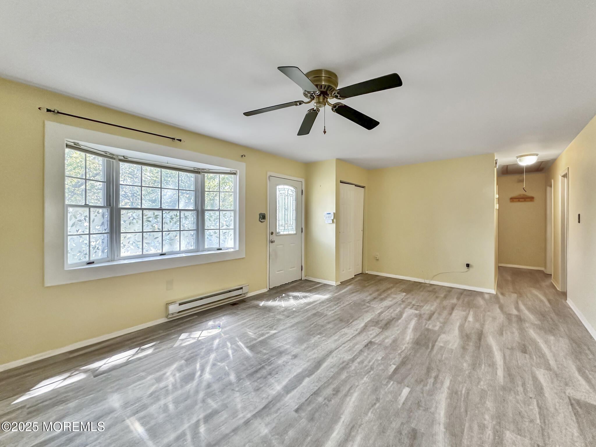 192 Dolphin Road Manahawkin, NJ 08050 - Photo 14 of 25 a view of empty room with wooden floor and fan