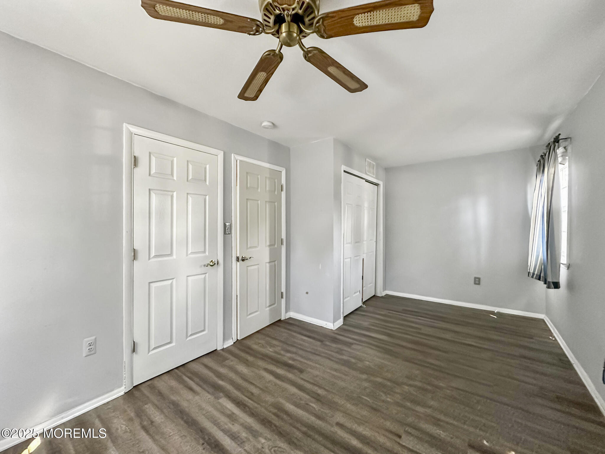 192 Dolphin Road Manahawkin, NJ 08050 - Photo 2 of 25 wooden floor in an empty room with a chandelier fan