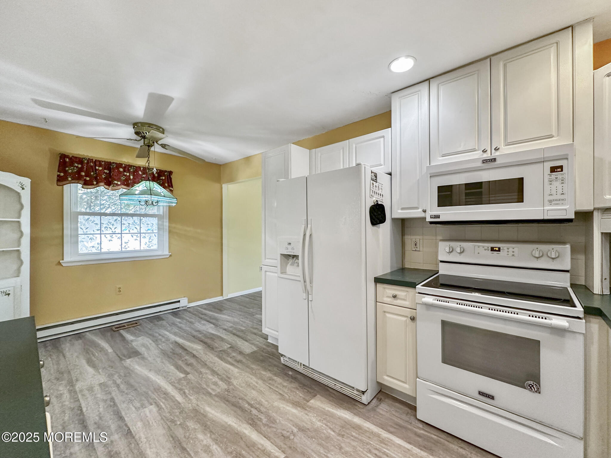 192 Dolphin Road Manahawkin, NJ 08050 - Photo 5 of 25 a kitchen with stainless steel appliances a stove a microwave and cabinets