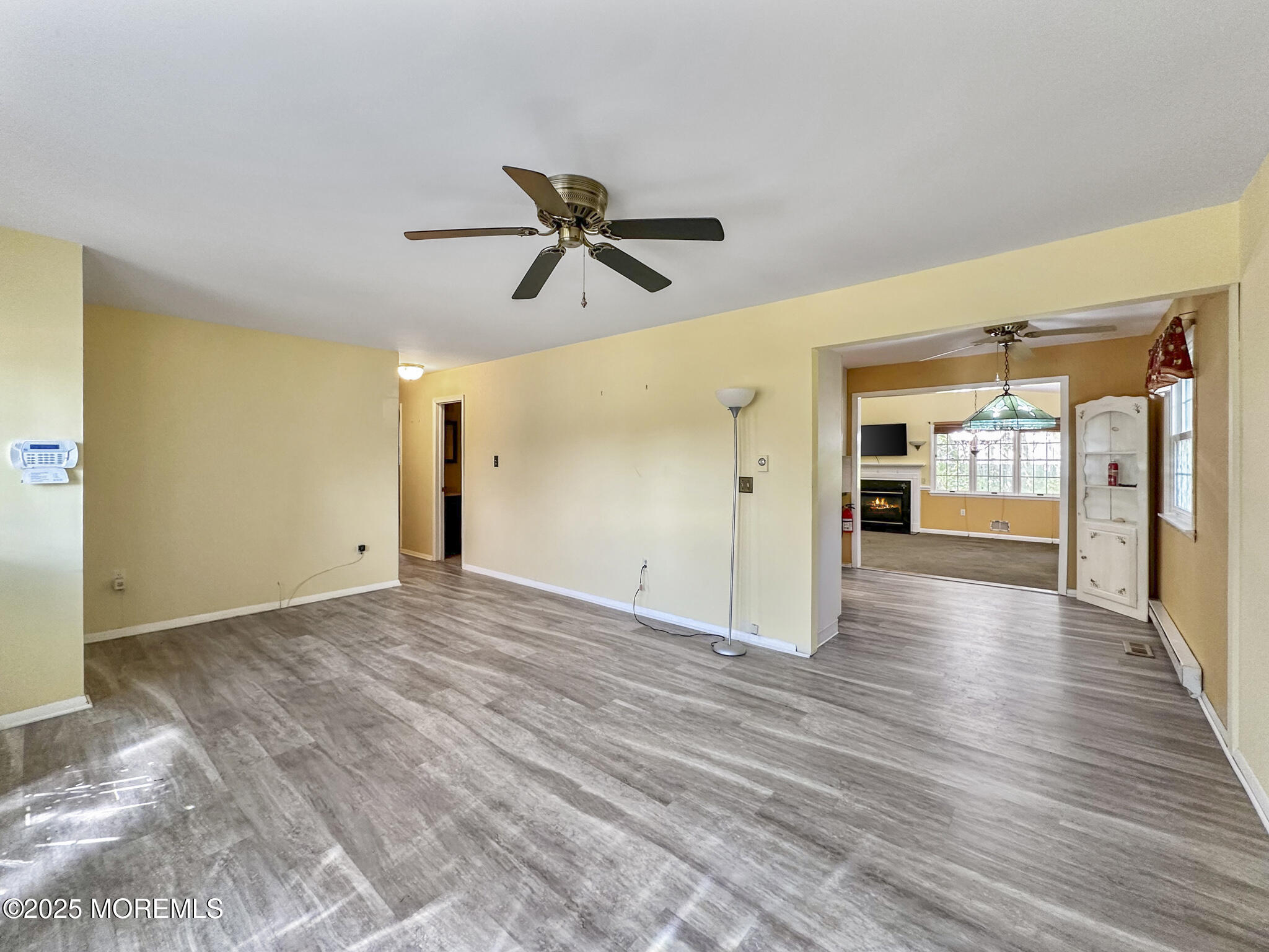 192 Dolphin Road Manahawkin, NJ 08050 - Photo 7 of 25 a view of empty room with wooden floor and fan