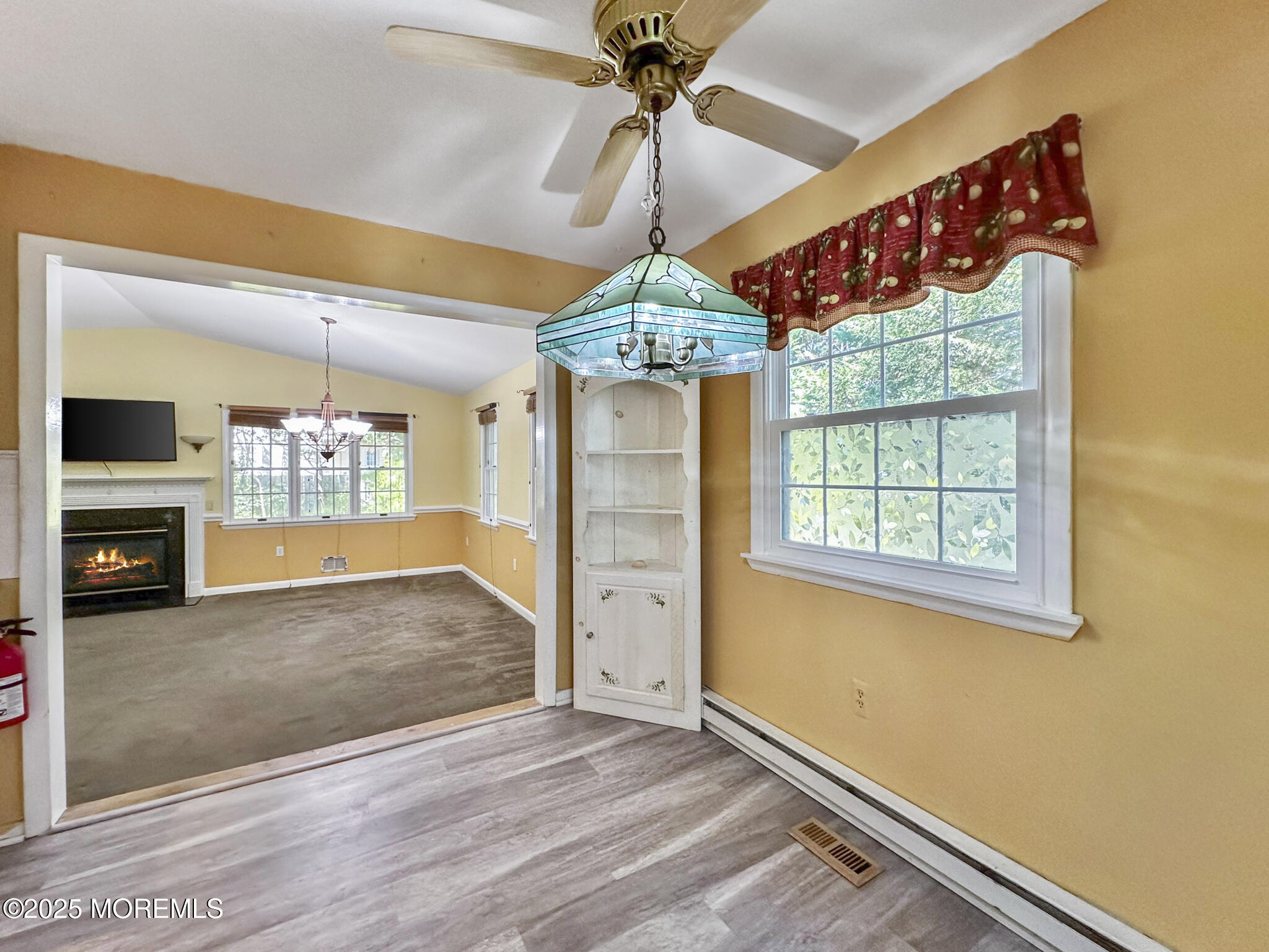192 Dolphin Road Manahawkin, NJ 08050 - Photo 8 of 25 an empty room with wooden floor a ceiling fan and windows