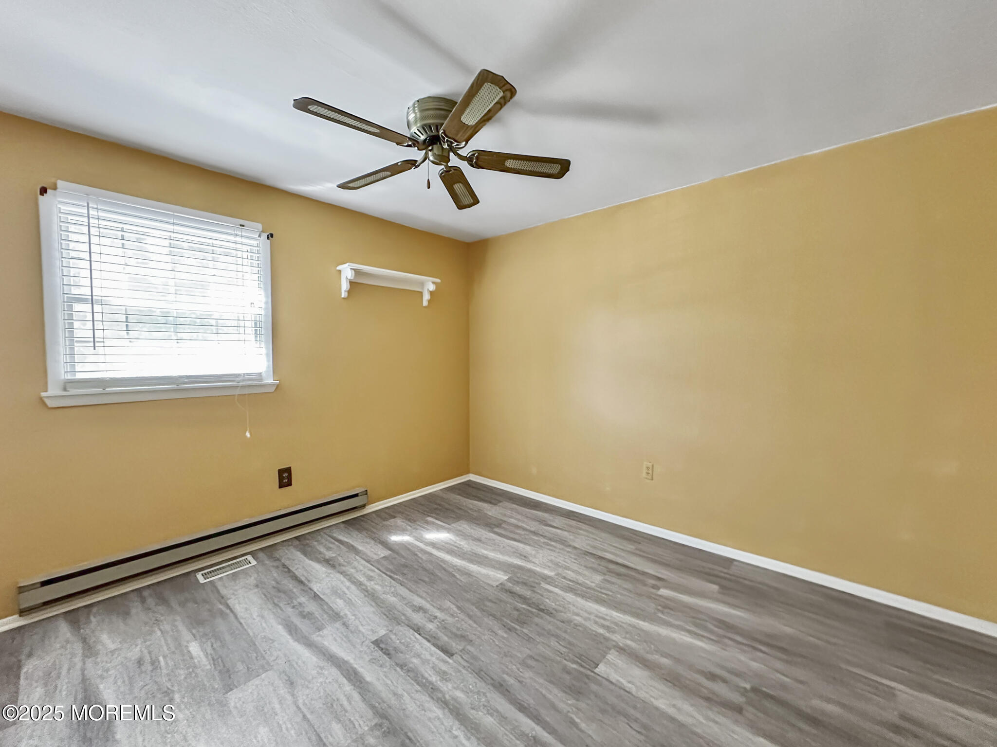192 Dolphin Road Manahawkin, NJ 08050 - Photo 9 of 25 a view of empty room with wooden floor and fan