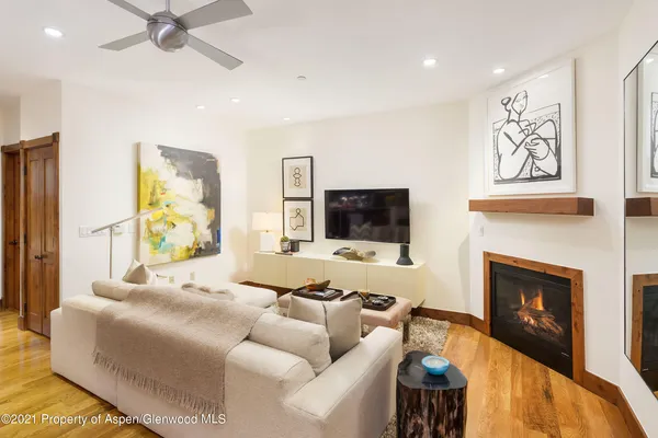 a living room with furniture a flat screen tv and a fireplace