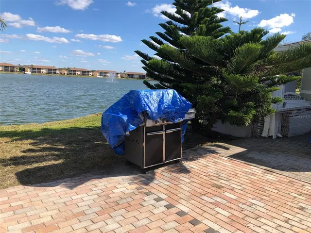 a view of a house with pool and chairs