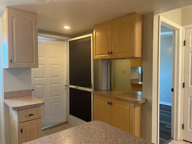a kitchen with cabinets and stainless steel appliances