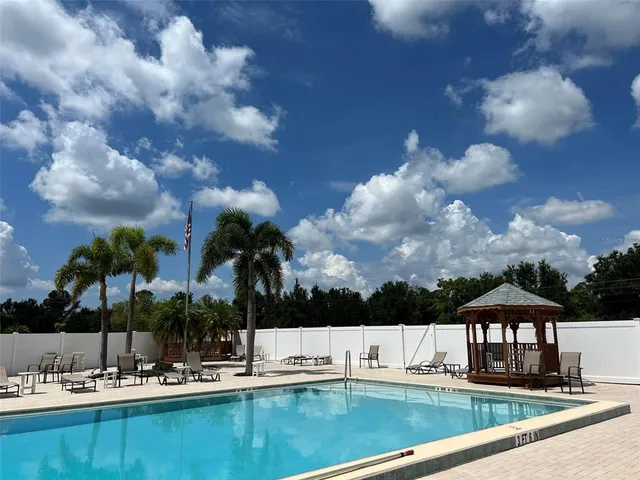 a view of swimming pool with outdoor seating