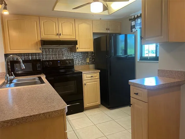 a kitchen with a refrigerator sink and stove