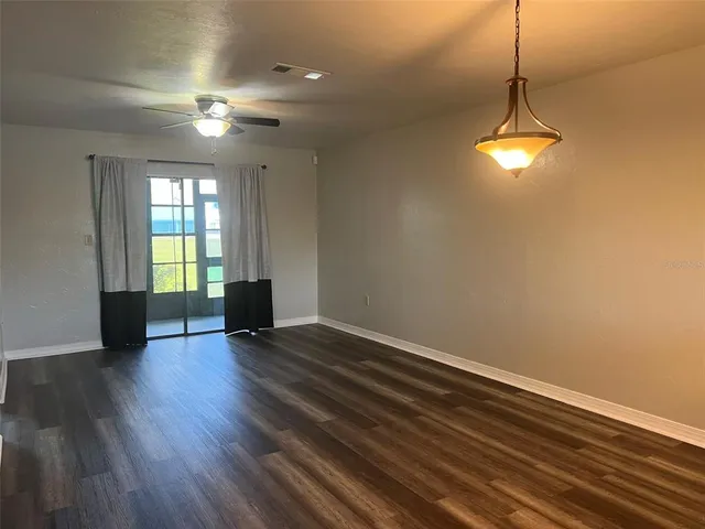 a view of room with window and hardwood floor